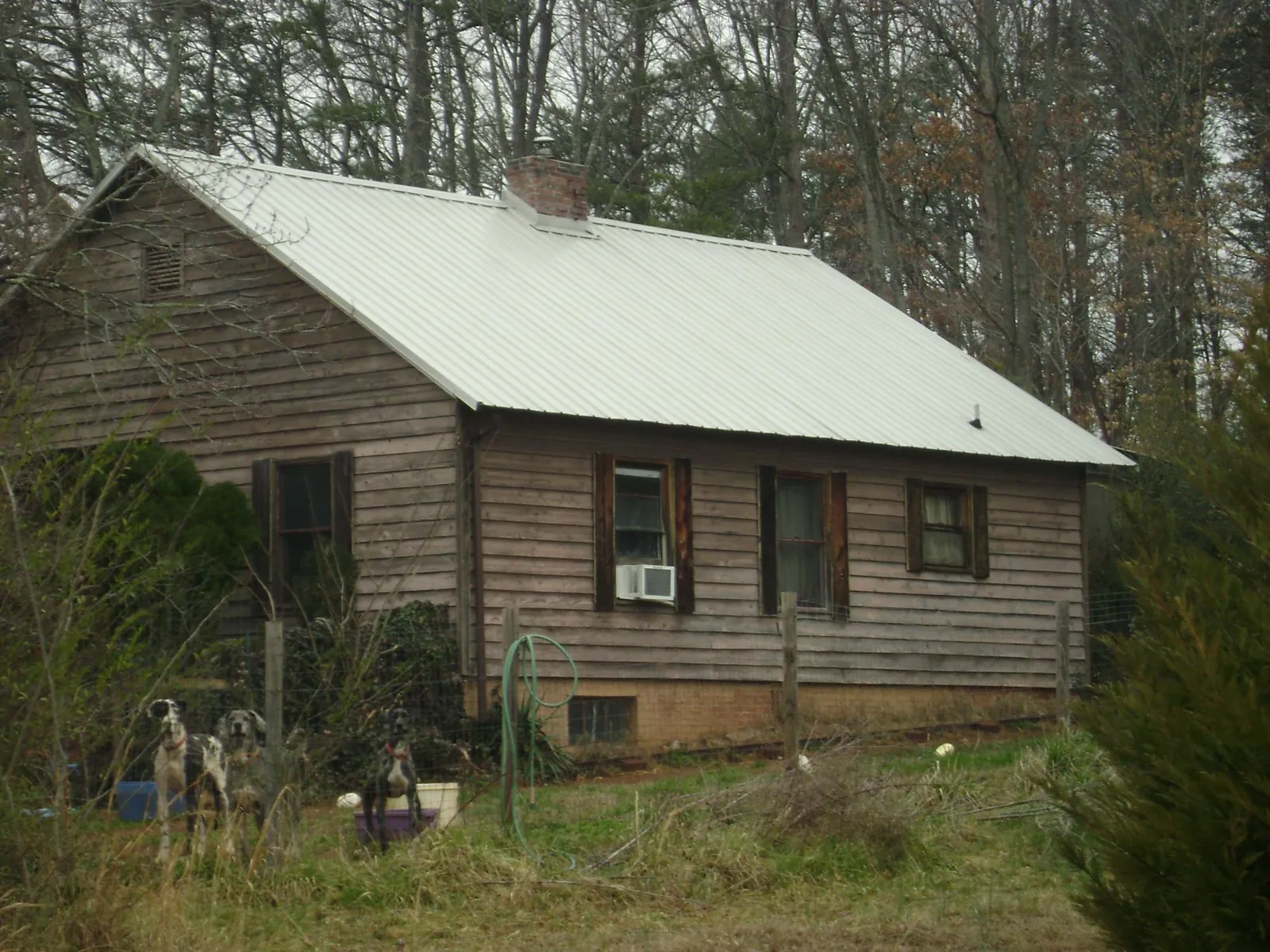 White metal roof on an old wood sided farmhouse, from a Metal Roof Installation job in Fremont
